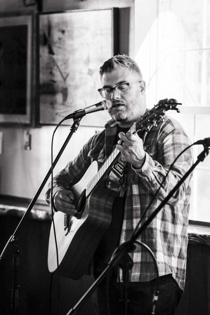 Chagrin Falls musician Mike Schell playing acoustic guitar.